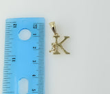 A delicate gold plated pendant featuring a twisted 'K' symbol.
A gold plated pendant in the shape of a stylized letter '