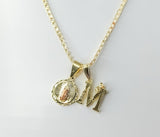 Gold plated Virgin Mary double pendants on a tri-color Cuban chain necklace.