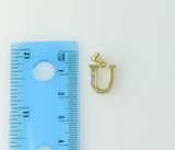 A delicate plated letter "U" pendant in a circular shape.
A small 14K gold-plated figurine of an anchor.
A gold-plated p